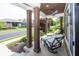 Relaxing front porch seating, supported by dark brown support pillars at 3429 Woodham Pl, Carmel, IN 46033
