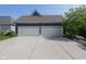 Detached two-car garage with an expansive driveway, blue siding, and white doors at 3429 Woodham Pl, Carmel, IN 46033