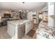 Spacious kitchen with stainless steel appliances, granite countertops and seamless flow to the living area at 3429 Woodham Pl, Carmel, IN 46033