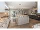 Open-concept kitchen featuring stainless steel appliances, granite countertops and seamless flow to the living area at 3429 Woodham Pl, Carmel, IN 46033