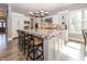 Spacious kitchen island with granite countertops, seating, and a modern lighting fixture at 3429 Woodham Pl, Carmel, IN 46033