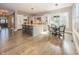 Open-concept kitchen featuring a large island, white cabinets, stainless steel appliances, and a breakfast nook with a view at 3429 Woodham Pl, Carmel, IN 46033