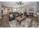 Open-concept living room with kitchen, dining area, and comfortable seating at 3429 Woodham Pl, Carmel, IN 46033
