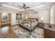 Elegant main bedroom with tray ceilings, hardwood floors, and a four-poster bed at 3429 Woodham Pl, Carmel, IN 46033