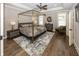 Elegant main bedroom with tray ceilings, hardwood floors, and a four-poster bed at 3429 Woodham Pl, Carmel, IN 46033