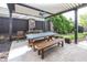 Outdoor patio with a wooden table, benches, grill, and ceiling fan at 3429 Woodham Pl, Carmel, IN 46033