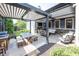 Outdoor patio area with a grill, dining table, seating, and retractable pergola at 3429 Woodham Pl, Carmel, IN 46033