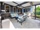 Covered patio featuring stone accents, comfortable couches, and shaded seating area at 3429 Woodham Pl, Carmel, IN 46033