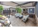 Inviting covered patio with a stone fireplace, TV, ceiling fan, and comfortable seating at 3429 Woodham Pl, Carmel, IN 46033
