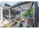 Outdoor patio area with a dining table, grill, couches, and retractable pergola at 3429 Woodham Pl, Carmel, IN 46033