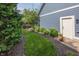 Manicured yard with a neatly trimmed grass path leading to a side entry door at 3429 Woodham Pl, Carmel, IN 46033