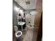 Bathroom with a pedestal sink, toilet, and shower/tub combo, needing renovation at 3440 Brewer Dr, Indianapolis, IN 46222
