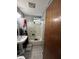 Modest bathroom with a combination shower and tub, pedestal sink, and tiled floors at 3440 Brewer Dr, Indianapolis, IN 46222