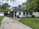 Exterior front view of home featuring yard with black bags, grill, and exposed studs at 3440 Brewer Dr, Indianapolis, IN 46222