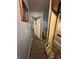 Hallway featuring blue walls, trim details, and an open doorway leading to another room at 3440 Brewer Dr, Indianapolis, IN 46222
