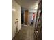 Hallway leading to bathroom, with some exposed plumbing and unfinished walls at 3440 Brewer Dr, Indianapolis, IN 46222
