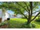 The back yard features a well-maintained lawn, mature trees, and a shed, creating a peaceful outdoor space at 409 Hanley St, Plainfield, IN 46168
