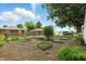 Spacious backyard featuring a garden area, green lawn, and mature trees providing shade and privacy at 409 Hanley St, Plainfield, IN 46168