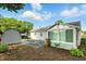 Backyard view showcasing the sunroom addition, shed, and landscaping at 409 Hanley St, Plainfield, IN 46168