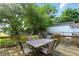 A spacious backyard deck provides an excellent space for outdoor dining and entertaining, surrounded by lush greenery and shade at 409 Hanley St, Plainfield, IN 46168