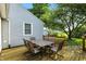 Outdoor dining on the backyard deck, ideal for gatherings and enjoying the serene, tree-filled scenery of the backyard at 409 Hanley St, Plainfield, IN 46168