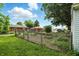 Spacious backyard featuring a garden area, green lawn, and mature trees providing shade and privacy at 409 Hanley St, Plainfield, IN 46168