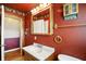 Well-lit bathroom featuring a vanity with mirror, and tiled floors at 409 Hanley St, Plainfield, IN 46168