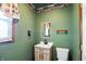 Half-bathroom with a single sink vanity, mirror, and toilet at 409 Hanley St, Plainfield, IN 46168