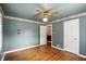 Cozy bedroom with hardwood floors, ceiling fan, and neutral wall color with decorative trim at 409 Hanley St, Plainfield, IN 46168