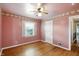 Bedroom with hardwood floors, a ceiling fan, and natural light from the window at 409 Hanley St, Plainfield, IN 46168