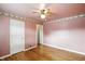 Inviting bedroom with hardwood floors, a ceiling fan, and warm neutral wall color at 409 Hanley St, Plainfield, IN 46168