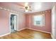 Comfortable bedroom featuring hardwood floors, a window, and a ceiling fan for added appeal at 409 Hanley St, Plainfield, IN 46168