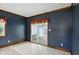 Cozy dining room featuring blue walls and a sliding glass door at 409 Hanley St, Plainfield, IN 46168