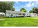 Beautiful single-story home with lush green lawn, a cozy front porch, and light blue exterior siding at 409 Hanley St, Plainfield, IN 46168
