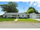 Charming single-story home featuring a well-maintained lawn, light blue siding, and a cozy front porch at 409 Hanley St, Plainfield, IN 46168