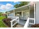 Cozy front porch with white railings, a covered area, and access to the front door at 409 Hanley St, Plainfield, IN 46168