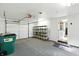 A well-lit, spacious garage offers ample room for parking and storage with additional shelving for organization at 409 Hanley St, Plainfield, IN 46168