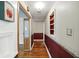 Hallway with hardwood floors, apple decor, and a white ceiling at 409 Hanley St, Plainfield, IN 46168