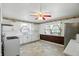 Spacious kitchen featuring white cabinets, brick accents, and vintage decorative touches at 409 Hanley St, Plainfield, IN 46168
