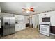 Kitchen features stainless steel refrigerator and white appliances at 409 Hanley St, Plainfield, IN 46168