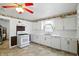 A kitchen with white appliances, and brick accent wall at 409 Hanley St, Plainfield, IN 46168