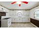 Bright kitchen featuring white appliances, brick accents, and vintage decorative touches at 409 Hanley St, Plainfield, IN 46168