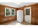 Bright kitchen featuring paneled walls, a modern refrigerator, and natural light from the windows at 409 Hanley St, Plainfield, IN 46168