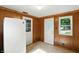 Bright kitchen featuring paneled walls, a modern refrigerator, and natural light from the windows at 409 Hanley St, Plainfield, IN 46168