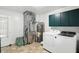 Functional laundry room featuring modern appliances, storage cabinets, and practical design elements at 409 Hanley St, Plainfield, IN 46168
