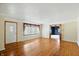 Inviting living room with pristine hardwood floors, a large window, and an open doorway to the next room at 409 Hanley St, Plainfield, IN 46168