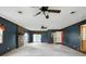 Spacious living room with ceiling fans, and brick fireplace at 409 Hanley St, Plainfield, IN 46168