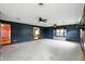 Spacious living room with carpeted flooring, a fan, and windows for natural light at 409 Hanley St, Plainfield, IN 46168