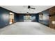 A living room with blue walls, carpeted floors, and a red brick fireplace at 409 Hanley St, Plainfield, IN 46168