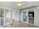 Light-filled sun room featuring tile floors, sliding glass doors, and many windows at 409 Hanley St, Plainfield, IN 46168